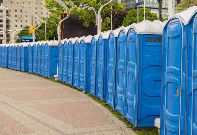 hygienic portable restrooms lined up at a beach party, ensuring guests have access to the necessary facilities while enjoying the sun and sand in Needham Heights